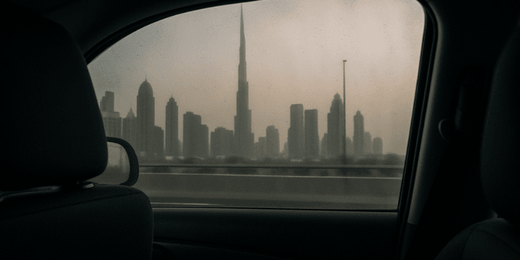 View of the Dubai skyline through a car window on an overcast morning